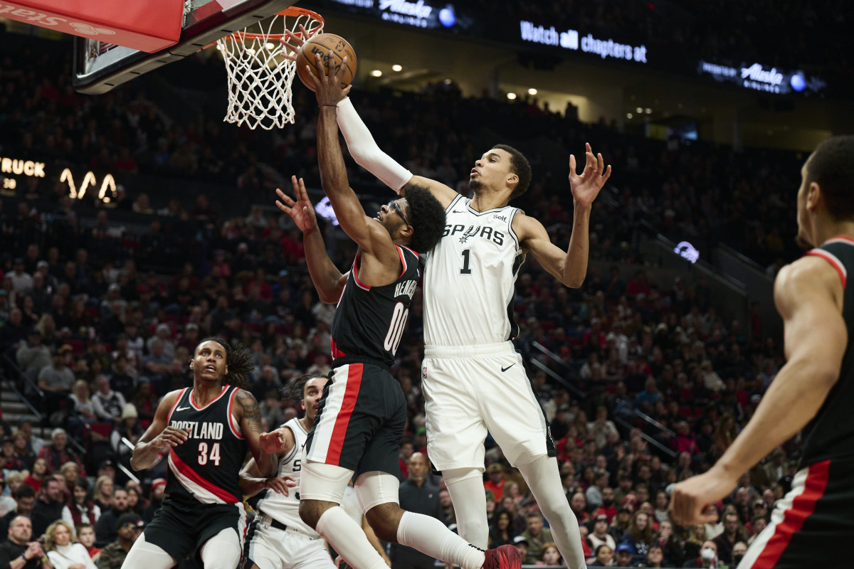 Dec 28, 2023; Portland, Oregon, USA; San Antonio Spurs center Victor Wembanyama (1) blocks a shot during the first half against Portland Trail Blazers guard Scoot Henderson (00) at Moda Center.